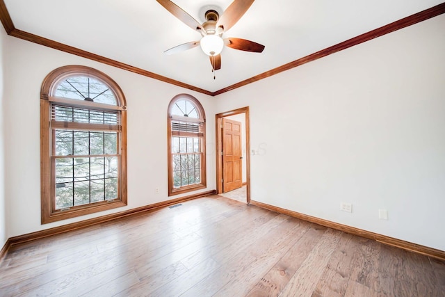 spare room featuring crown molding, ceiling fan, and light wood-type flooring