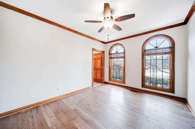 spare room with ornamental molding, ceiling fan, and light hardwood / wood-style flooring