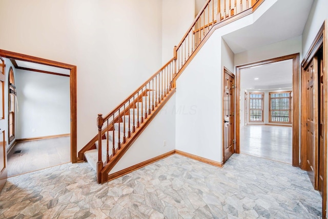 stairs featuring a towering ceiling