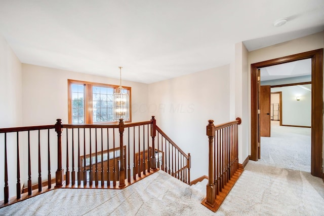 stairway featuring carpet flooring and a notable chandelier