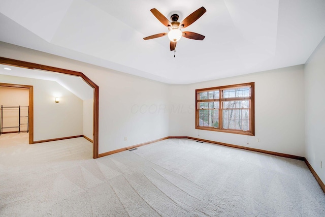 unfurnished room with light colored carpet and ceiling fan