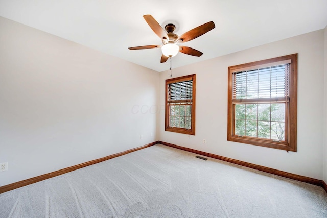 empty room with ceiling fan and carpet