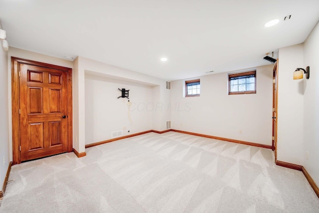 basement featuring light colored carpet