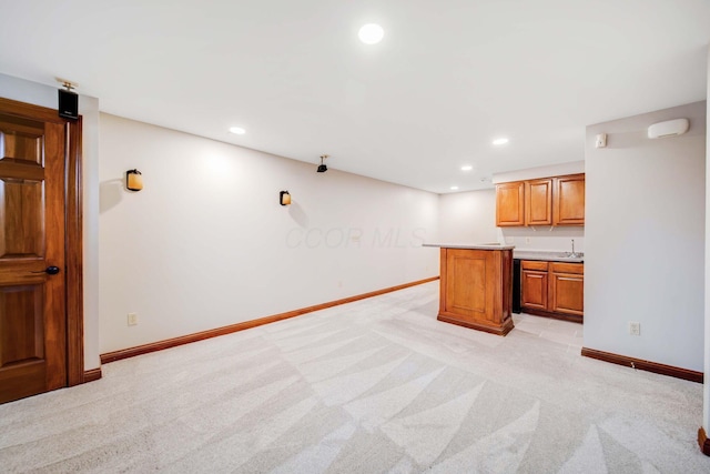 kitchen with light colored carpet, a center island, and sink