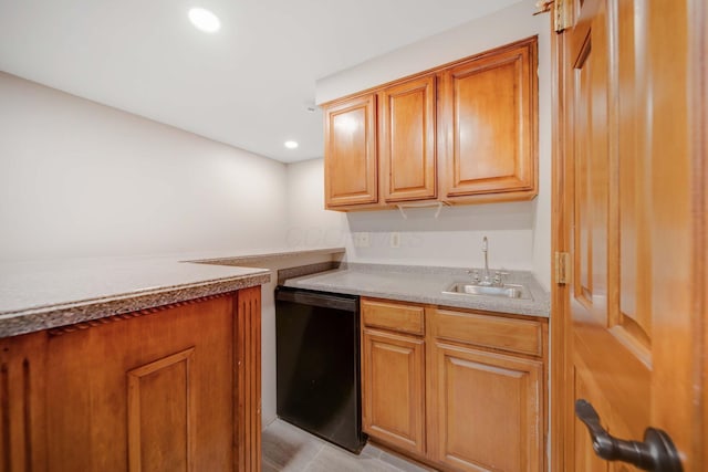 kitchen with sink, black dishwasher, and light tile patterned flooring