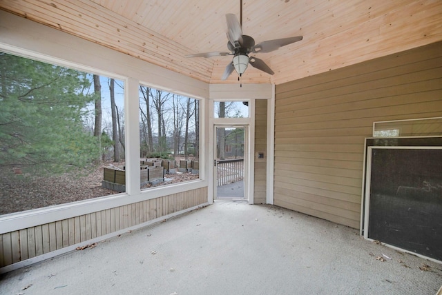 unfurnished sunroom with wooden ceiling and ceiling fan