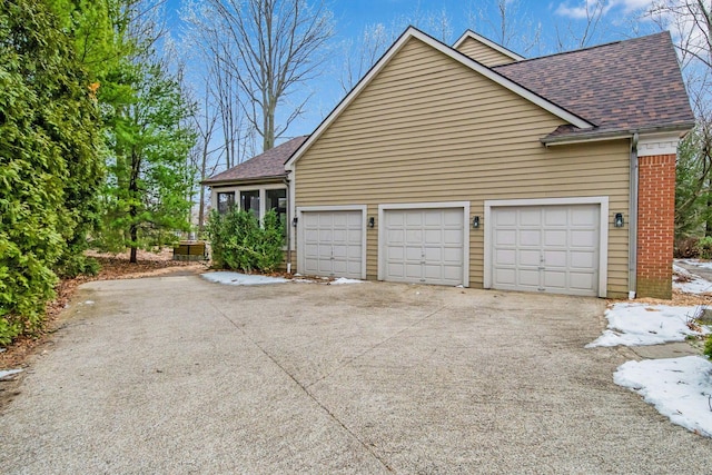 view of side of home featuring a garage