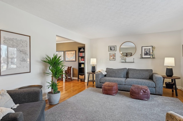 living room with hardwood / wood-style floors and a textured ceiling