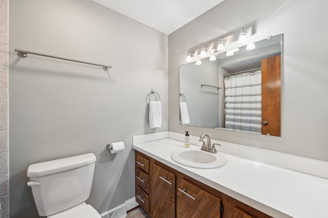 bathroom with vanity, toilet, and a shower with shower curtain