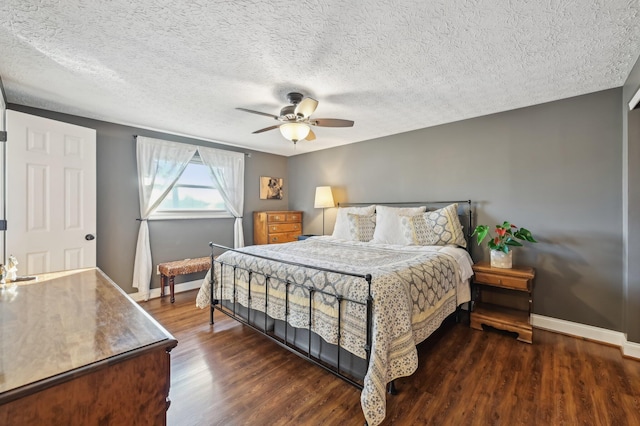 bedroom with a textured ceiling, dark wood-type flooring, and ceiling fan