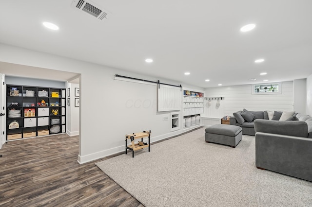 living room featuring wood-type flooring and a barn door