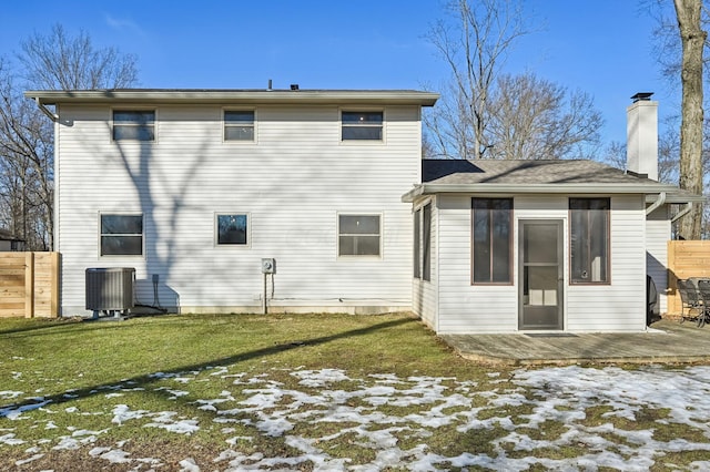 snow covered property with a yard and central air condition unit