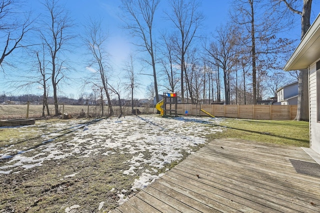 deck featuring a lawn and a playground