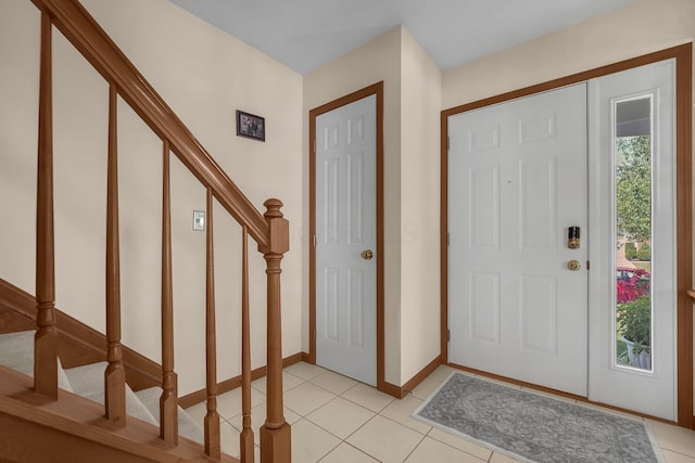 foyer entrance with light tile patterned flooring