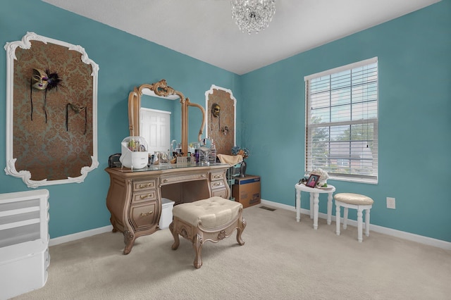 sitting room with light colored carpet and a chandelier