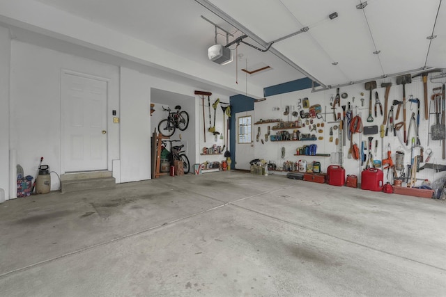 garage featuring a garage door opener and a workshop area