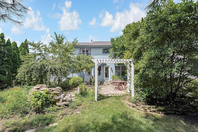 back of property featuring a yard, a pergola, and a patio area