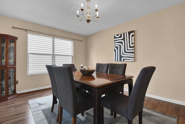 dining room featuring an inviting chandelier and hardwood / wood-style flooring