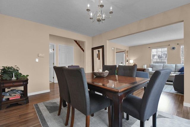 dining space featuring a notable chandelier and dark hardwood / wood-style floors