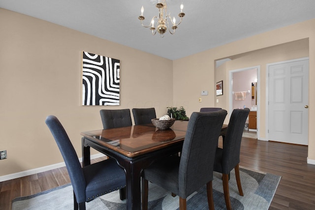 dining space with an inviting chandelier and dark hardwood / wood-style flooring