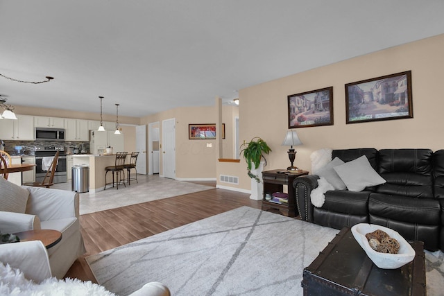 living room with light hardwood / wood-style flooring