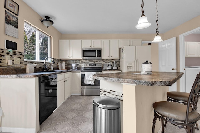 kitchen with pendant lighting, a breakfast bar, backsplash, stainless steel appliances, and white cabinets