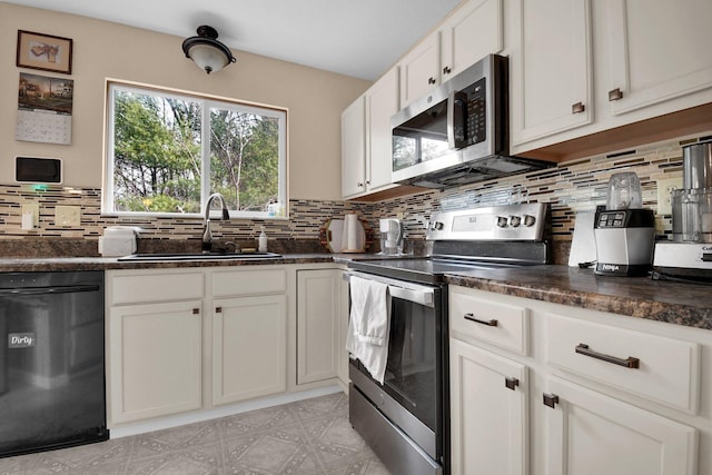 kitchen featuring tasteful backsplash, stainless steel appliances, sink, and white cabinets