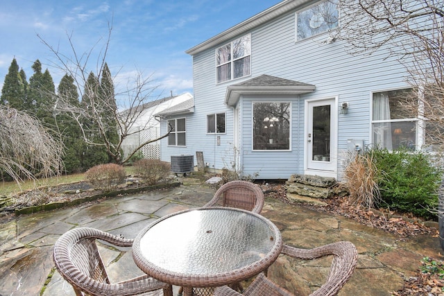 back of house with central AC unit and a patio