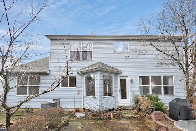 back of house featuring central AC unit and a patio area