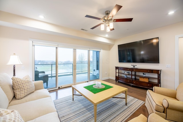 living room featuring ceiling fan and wood-type flooring