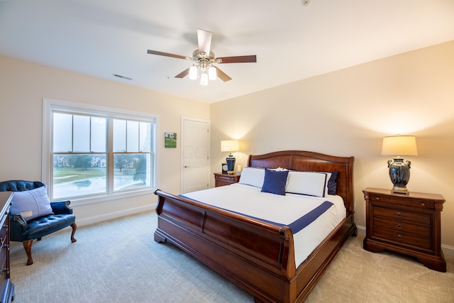 bedroom featuring light carpet and ceiling fan