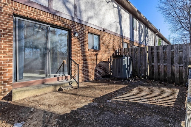 view of side of property with central AC unit