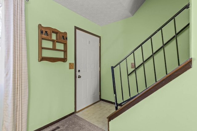 foyer featuring a textured ceiling