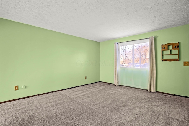 carpeted spare room with a textured ceiling