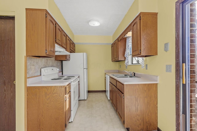 kitchen featuring tasteful backsplash, sink, and white appliances