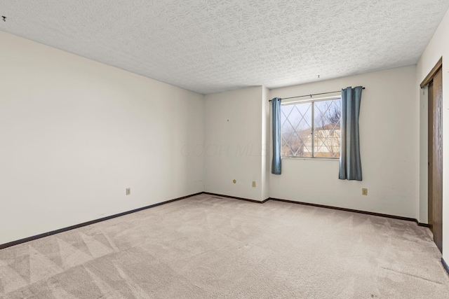 unfurnished bedroom with light colored carpet and a textured ceiling