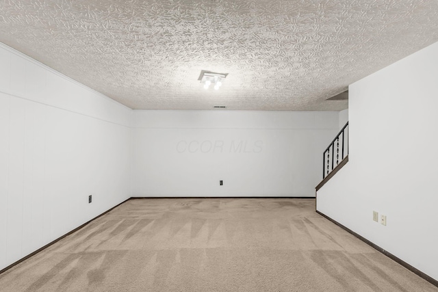 interior space featuring carpet floors and a textured ceiling