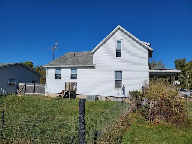 back of property featuring central AC