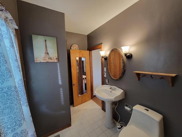 bathroom featuring tile patterned flooring and toilet