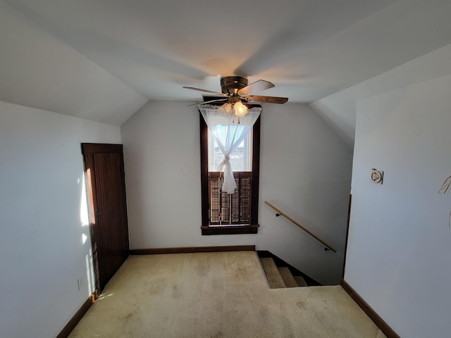 additional living space with ceiling fan, vaulted ceiling, and light carpet