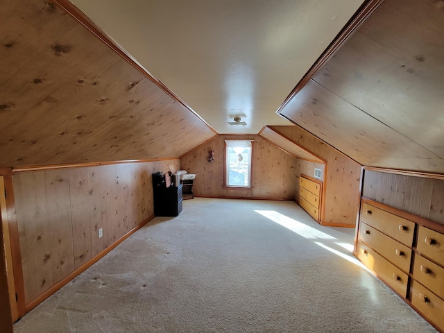 bonus room featuring lofted ceiling, light carpet, and wood walls