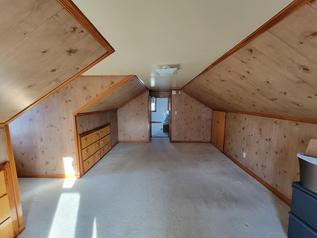 bonus room featuring light carpet, vaulted ceiling, and wooden walls