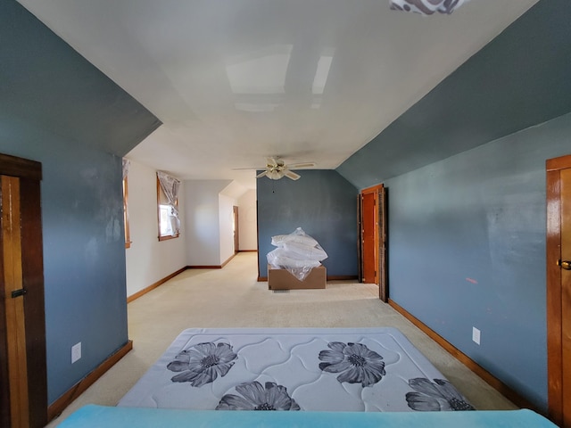 carpeted bedroom featuring ceiling fan and vaulted ceiling