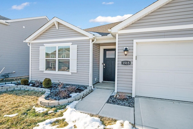 doorway to property with a garage