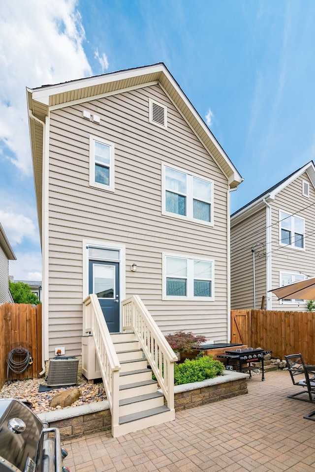 back of property featuring central AC and a patio area