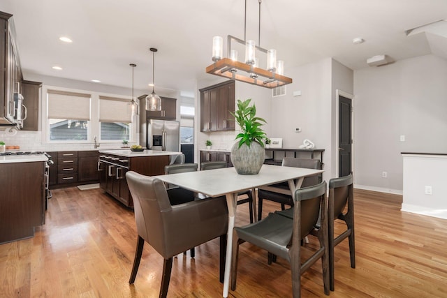 dining space featuring light wood-type flooring