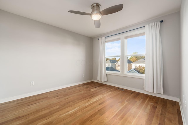 spare room with ceiling fan and hardwood / wood-style floors