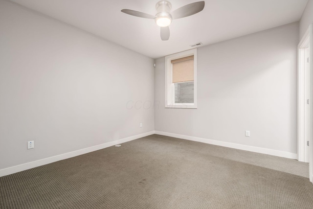 unfurnished room with ceiling fan and carpet flooring