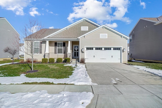 view of front of house featuring a porch, a garage, and a front lawn