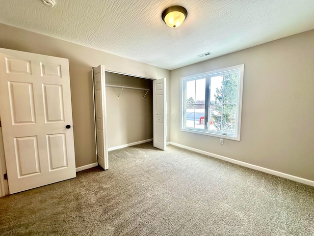 unfurnished bedroom featuring carpet and a closet